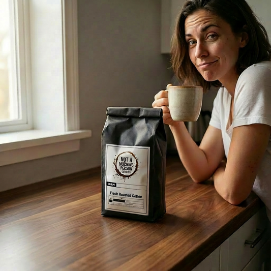 woman holding a cup of coffee with a pleasantly surprised look on her face with a bag of not a morning person coffee co on a clean countertop.